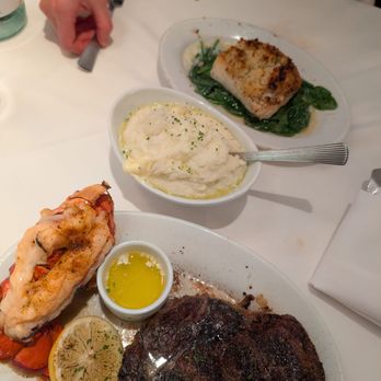 Ruth's Chris Steak House - 16oz prime ribeye + lobster tail from "classic combo" with potato side option, note also the sea-bass a la carte entree. - Steakhouses Near Me - Waltham, Massachusetts