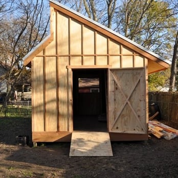 MSS Contracting - a small wooden outhouse in a yard - General Contractors Near Me - Austin, Texas