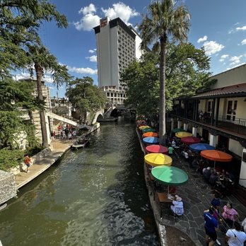 Casa Rio - Street view looking down toward the outdoor seating (colorful umbrellas) - Mexican Near Me - San Antonio, Texas Casa Rio - Street view looking down toward the outdoor seating (colorful umbrellas) - Mexican Near Me - San Antonio, Texas