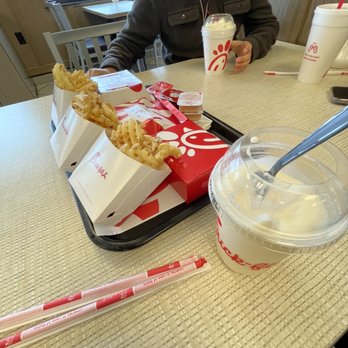 Chick-fil-A - ows a woman sitting at a table in a fast food restaurant - Fast Food Near Me - Austin, Texas