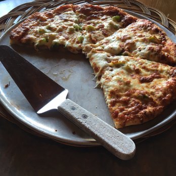 O'Brien's Eatery & Pub - a pizza on a plate with a knife - Pizza Near Me - Ottawa, Ontario O'Brien's Eatery & Pub - a pizza on a plate with a knife - Pizza Near Me - Ottawa, Ontario