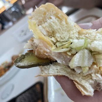 Ember - a person holding a half eaten sandwich - American Near Me - Houston, Texas