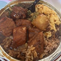Jerk chicken platter with rice n peas, mac n cheese and greens. delish!
