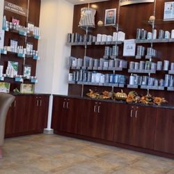 Hand & Stone Massage and Facial Spa - Skin care products displayed in reception area