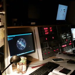 Inside the observatory, screens and equipment connected to the large telescop3