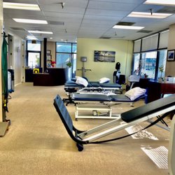Rancho Del Mar Physical Therapy - Here we have two treatment tables, one traction table and one total gym all in an open office setting.