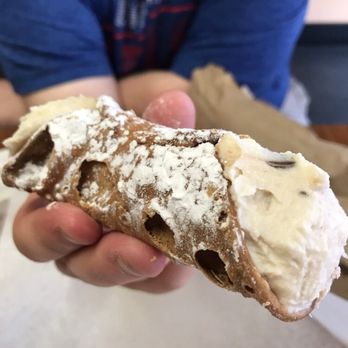 Chucks Pizza - a person holding a pastry - Pizza Near Me - Buffalo, New York Chucks Pizza - a person holding a pastry - Pizza Near Me - Buffalo, New York