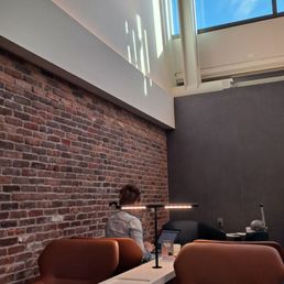 a man sitting in a lounge area a man sitting in a lounge area
