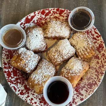 Sunny Bay Cafe - The famous beignets! Dipping sauces were raspberry, chocolate sauce, and caramel. - American Near Me - Rehoboth Beach, Delaware Sunny Bay Cafe - The famous beignets! Dipping sauces were raspberry, chocolate sauce, and caramel. - American Near Me - Rehoboth Beach, Delaware