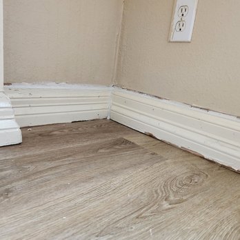 Flooring Direct - Exposed drywall gaps and damaged baseboards - Flooring Near Me - Dallas, Texas