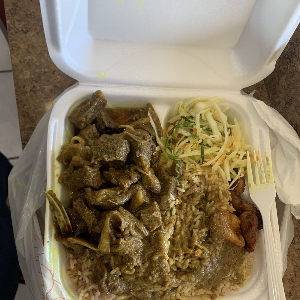 Curry, goat, rice, and peas with cabbage and banana Curry, goat, rice, and peas with cabbage and banana