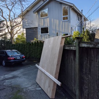Azimuth Works - a wooden door leaning against a fence - General Contractors Near Me - Seattle, Washington