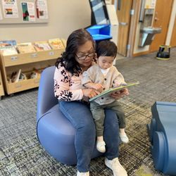 Multnomah County Library - Grandma (Mak Yay in Khmer) reading to her little man.