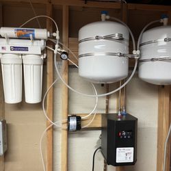 Point of use reverse osmosis water treatment system with insta-hot water tank for kitchen sink water dispenser.
