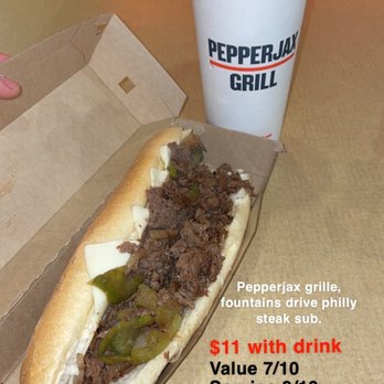 PepperJax Grill - Philly steak - A Philly steak sub with beef, green peppers, and cheese in a cardboard box, accompanied by a large drink in a PepperJax Grill cup. - Cheesesteaks Near Me - Cedar Rapids, Iowa