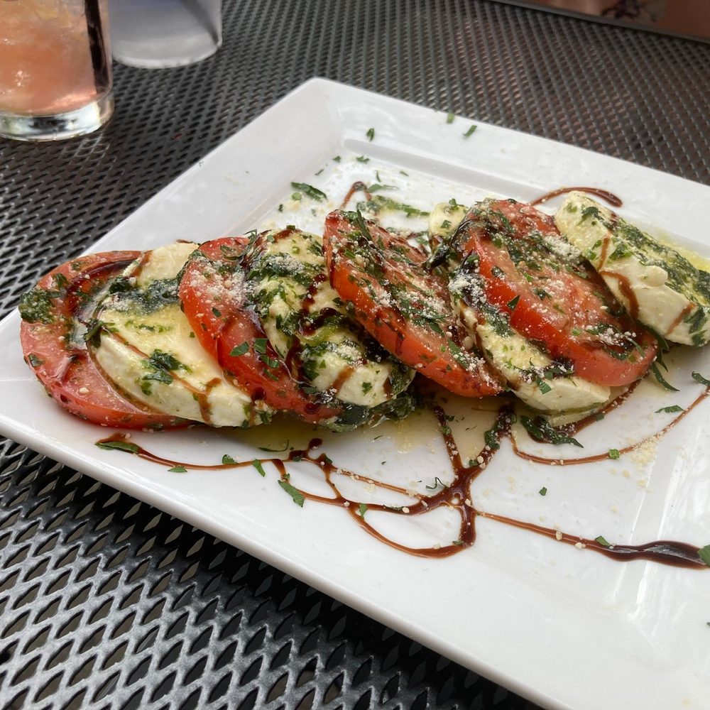 Orbis Lounge - a plate of tomatoes and mozzarella - Lounges Near Me - Syracuse, New York Orbis Lounge - a plate of tomatoes and mozzarella - Lounges Near Me - Syracuse, New York