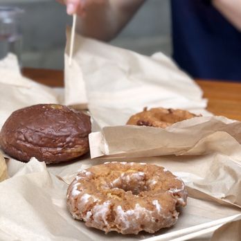 Doughnut Vault - Front is buttermilk, two in back are seasonal (chocolate covered orange jelly filled and a bourbon caramel pecan) - Donuts Near Me - Chicago, Illinois Doughnut Vault - Front is buttermilk, two in back are seasonal (chocolate covered orange jelly filled and a bourbon caramel pecan) - Donuts Near Me - Chicago, Illinois