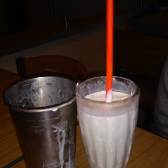Smashburger - a glass of milkshake and a metal cup - Burgers Near Me - Kingwood, Texas
