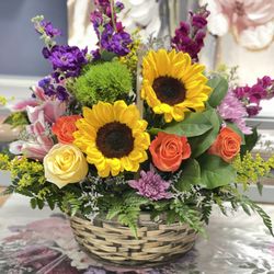 Terra Florist - Bright and cheerful Blooms in a Basket. Send a smile with this sunny arrangement.