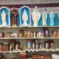 Large outdoor vinyl statues and small resin statues of common saints