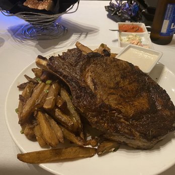 Firefly - Bone-in Ribeye and soggy fries with horseradish cream sauce - Steakhouses Near Me - Panama City Beach, Florida
