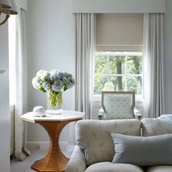 Roman Shades with stationary side panels give this room a clean elegance.