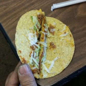 Del Taco - a hand holding a tortilla - Mexican Near Me - Apple Valley, California Del Taco - a hand holding a tortilla - Mexican Near Me - Apple Valley, California