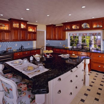 Tudor Kitchen Remodel With Contrasting Cabinets And Limestone Tile