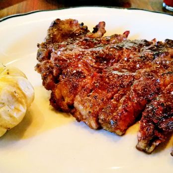 Lamberts Downtown Barbecue - MUSTARD & BROWN SUGAR CRUSTED USDA PRIME RIBEYE with WHOLE ROASTED GARLIC BULB - Barbeque Near Me - Austin, Texas