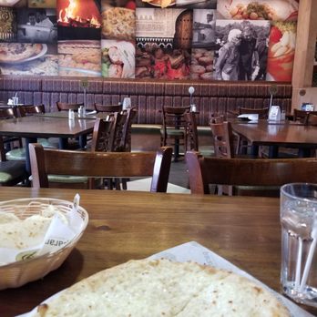 Paramount Fine Foods - a table with a bowl of soup and a large flatbread - Middle Eastern Near Me - Hamilton, Ontario