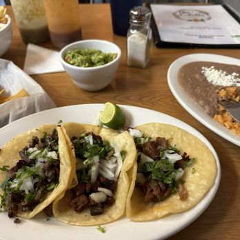 Mi Calvillo - Carnitas taco. Al pastor taco without pineapple (   )  Carne Asada (steak) taco. Rice and beans - Mexican Near Me - Durham, North Carolina
