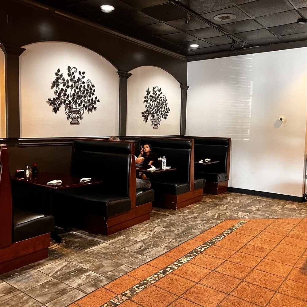 Chopsticks - a woman sitting in a booth at a restaurant - Chinese Near Me - Tulsa, Oklahoma Chopsticks - a woman sitting in a booth at a restaurant - Chinese Near Me - Tulsa, Oklahoma