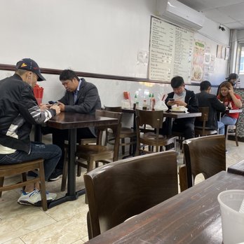 Chun Bai Wei - a group of people sitting at a table in a restaurant - Chinese Near Me - Brooklyn, New York