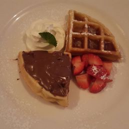 Waffles w/Nutella, maple syrup, strawberries, whipped cream & mint.
