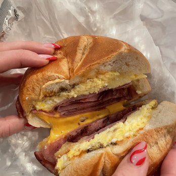 Roadhouse Deli - a person holding a sandwich - Delis Near Me - Boonton, New Jersey