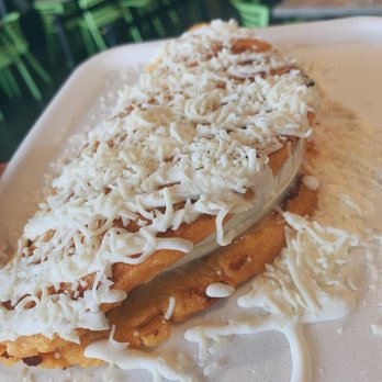Los Verdes - a plate of food with cheese on top - Colombian Near Me - Miami, Florida