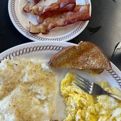 Scrambled eggs, grits, wheat toast and chewy bacon