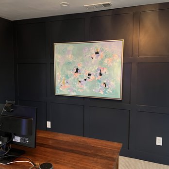 Texas Trim Company - a work area with a computer and a painting - General Contractors Near Me