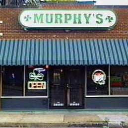 a brick building with a green awning