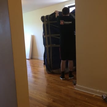 TB Moving & Storage - the moving crew packing the couch for it's move - Movers Near Me - Fairfax, Virginia TB Moving & Storage - the moving crew packing the couch for it's move - Movers Near Me - Fairfax, Virginia