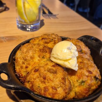 Kitchen Social - CHEDDAR + SCALLION BISCUITS Our signature biscuits with honey butter. 8 - New American Near Me - Dublin, Ohio