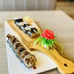 Koi Sushi - "salmon skin maki roll" front (special order) 2 yellowtail & scallion rolls in back. "la vie en rose" Excellent OuiOui :),.