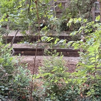 Brothers Landscaping - View of bottom two tiers of new retaining wall. Top tier is beneath the large fence. - Tree Services Near Me - Garland, Texas