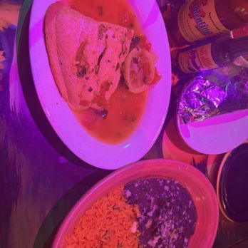 Senor Salsa - Tequila SalmonD. Mexican Rice C. Refried Beans - A meal featuring a quesadilla with lemon slices, Mexican rice, and refried beans, served on a white plate with hot sauce bottles nearby. - Mexican Near Me - Abington, Pennsylvania
