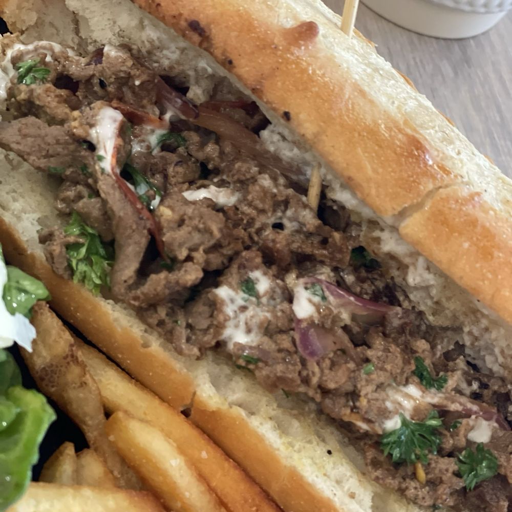 Beef sandwich with a tahini sauce.