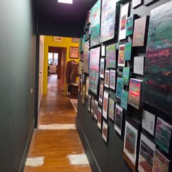 Upstairs hallway is full of beautiful art.