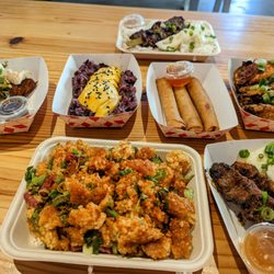 Sek-se-Fud-ko - L to R: Laotian sausage, mango sticky rice, chicken egg rolls, garlic chicken wings. Bottom: crispy fried rice and ribeye skewers