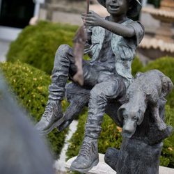 This is a bronze boy with Dog Fishing Statue