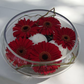 Petal Town Flowers - Our centerpieces were made exactly as we had requested... floating gerberas with a candle, black stones and water - Florists Near Me