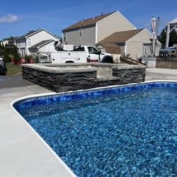 BRP Construction masonry - Stone tanning lounge added with a pool deck